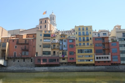 brown and white concrete building near body of water during daytime